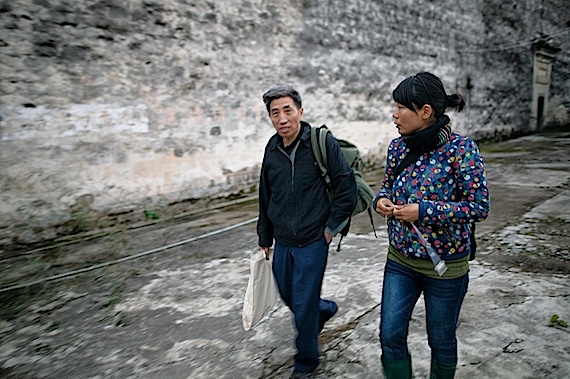LIANG Shaoji is checking exhibition space with project manager SHAO Keman.